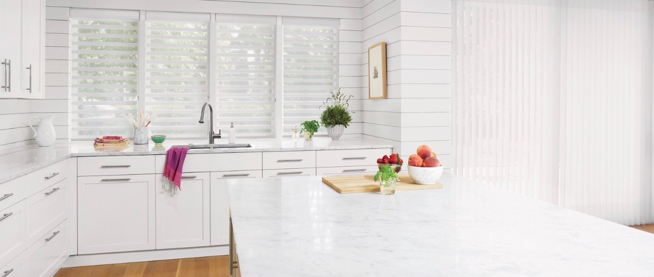 Bright White kitchen with white counters and white shades in the window